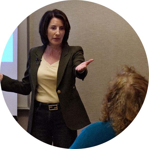 Julie Farha addressing an attendee of a Soul Specialties™ workshop in Scottsdale, Arizona.
